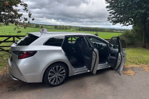 grey toyota car with side dors oppened viewd from the side